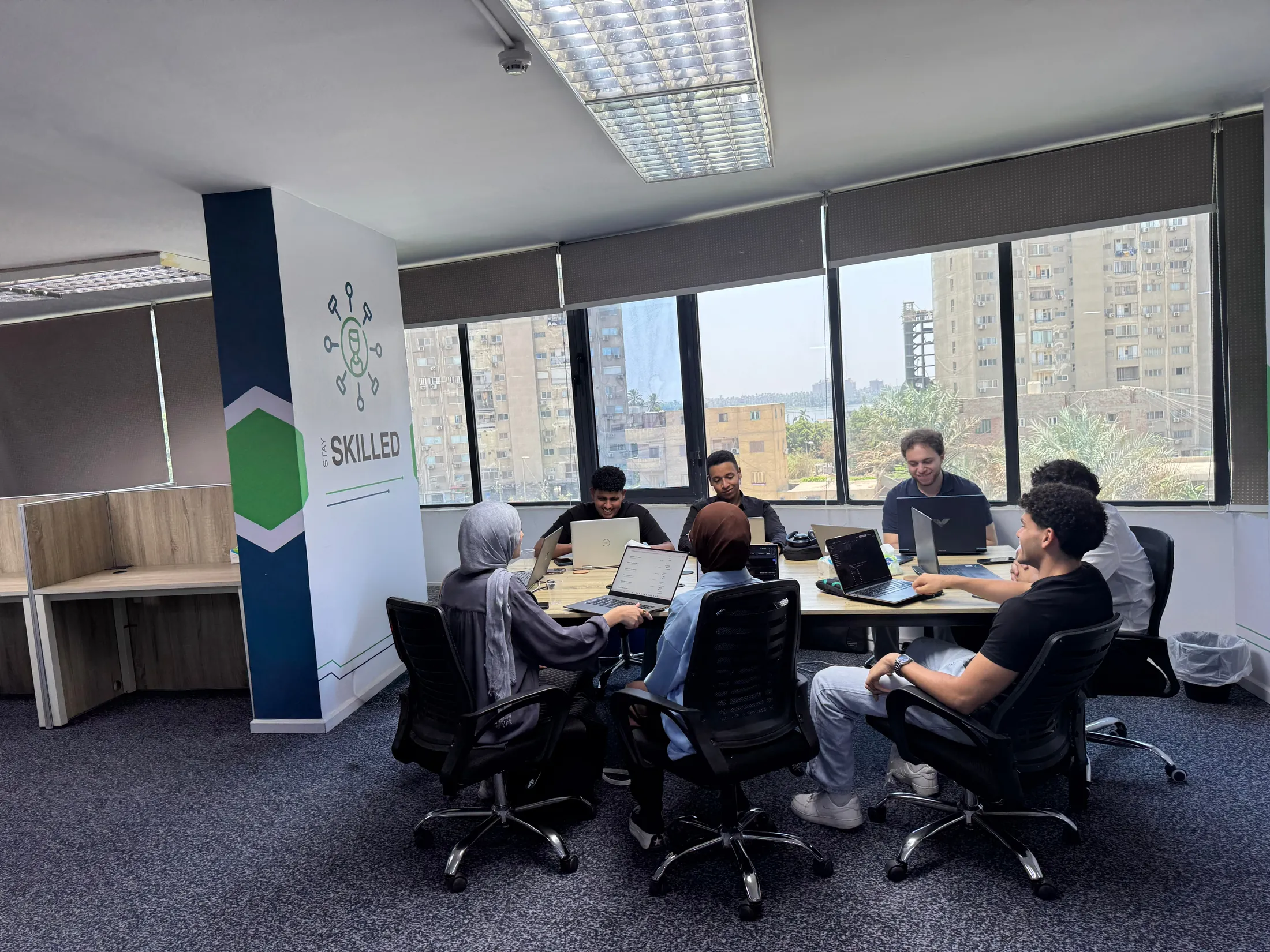 Qeema engineers working together at the Qeema office